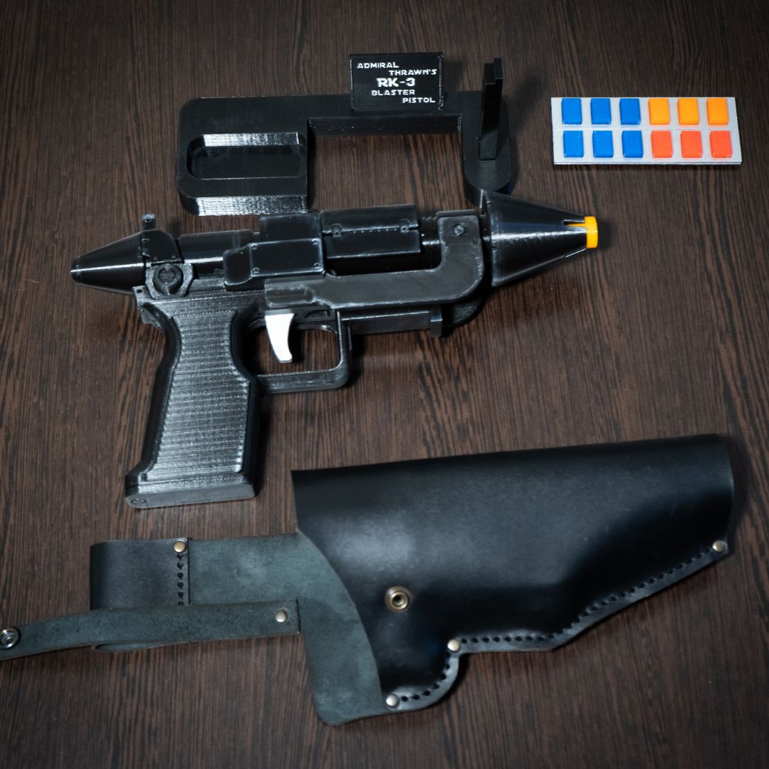 Admiral Thrawn RK-3 blaster pistol replica with orange tip, black leather holster, and customization accessories for Star Wars cosplay