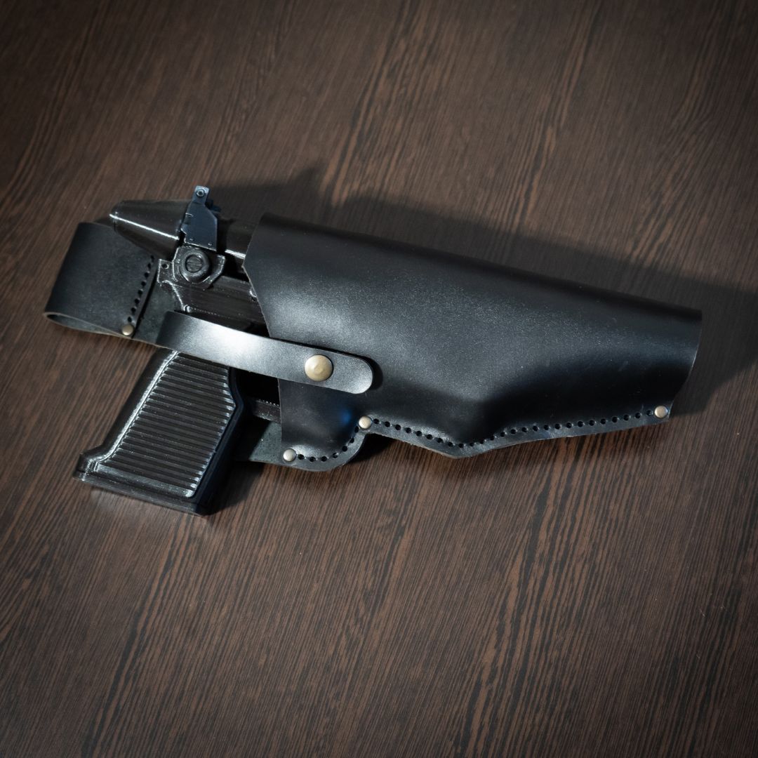 Admiral Thrawn RK-3 blaster pistol replica with black leather holster for Star Wars cosplay on wooden surface