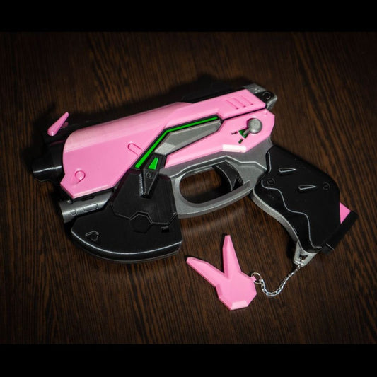 D.Va cosplay gun prop replica in pink and black with green accents, lightweight plastic design for conventions and photoshoots