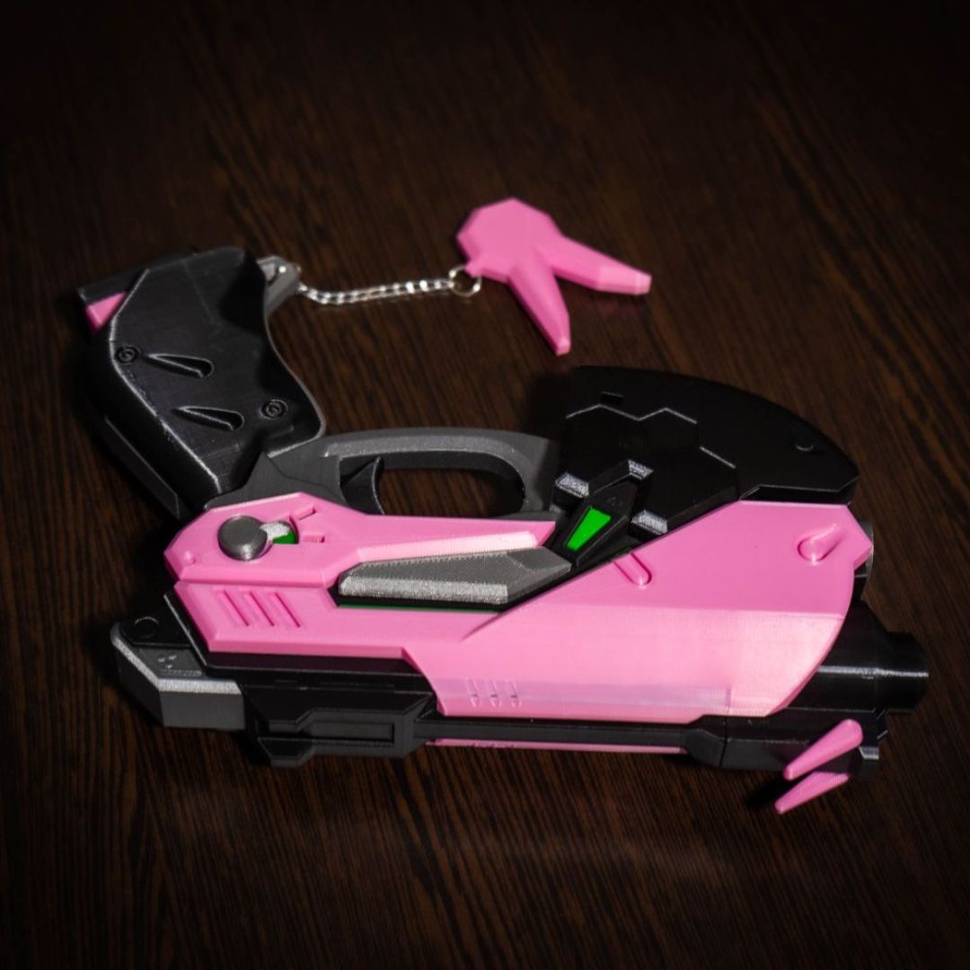 D.Va cosplay gun prop replica with pink and black design, lightweight and hand-painted details.