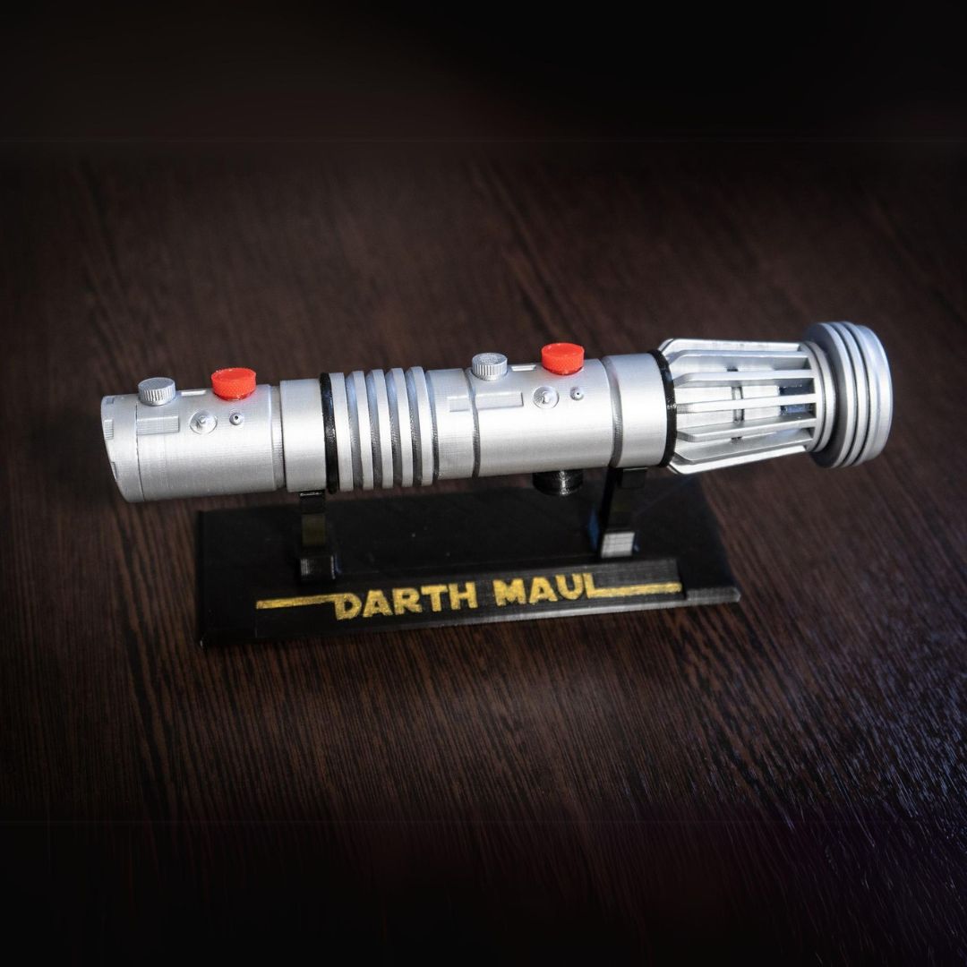 Darth Maul single-bladed lightsaber replica prop made of durable plastic on a display stand labeled Darth Maul