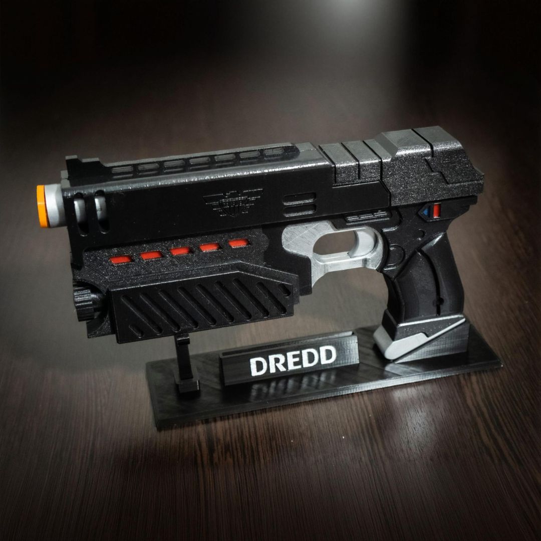 Judge Dredd Lawgiver cosplay prop gun replica with detailed design and display stand