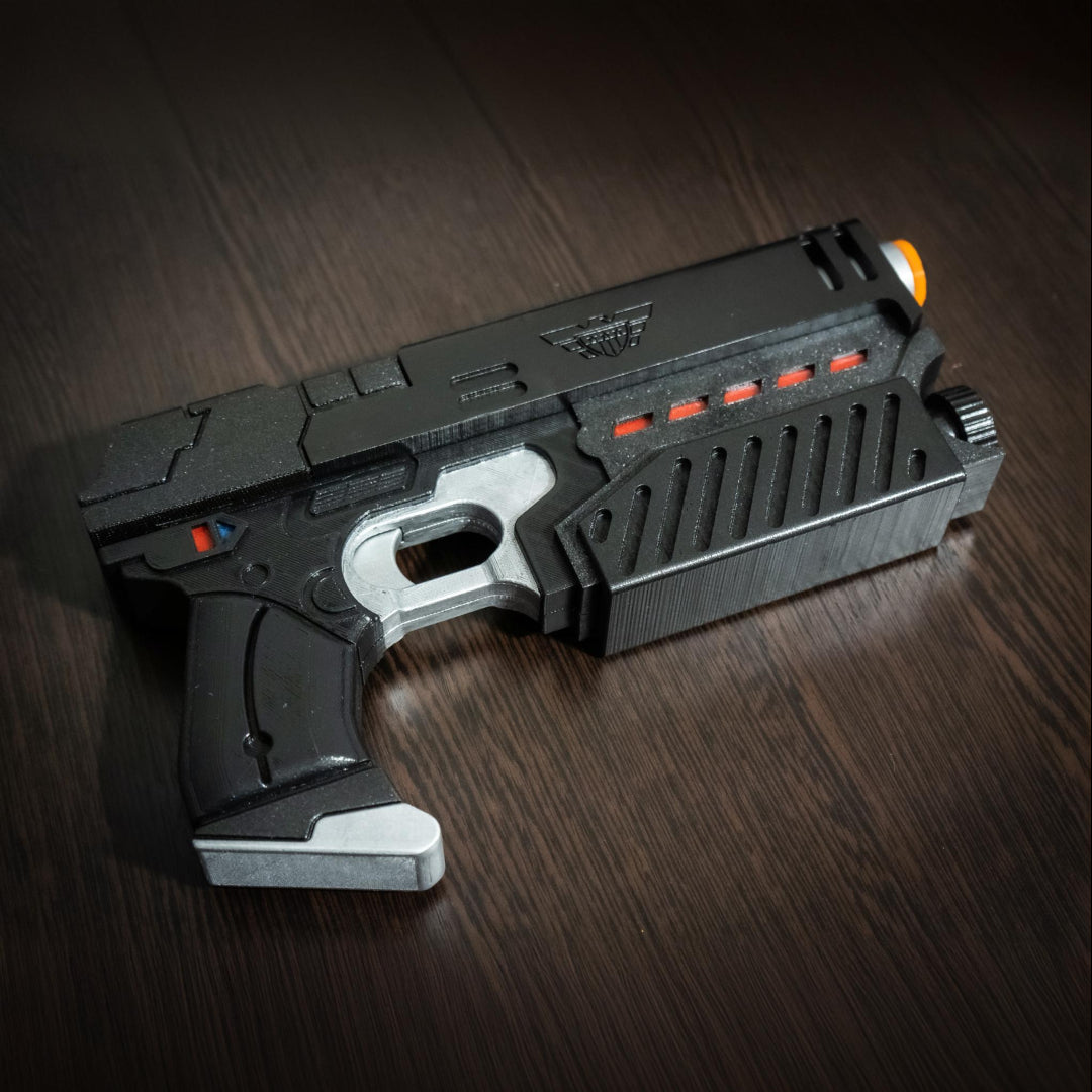 Judge Dredd Lawgiver cosplay prop gun, black detailed replica with orange tip and silver accents, 11-inch cosplay accessory.