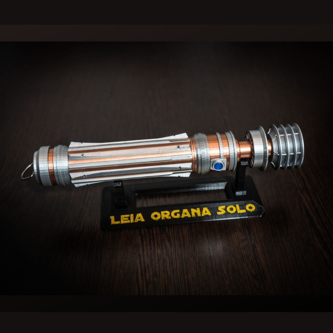 Replica of Leia Organa Lightsaber from Star Wars IX Rise of Skywalker with detailed craftsmanship on display stand