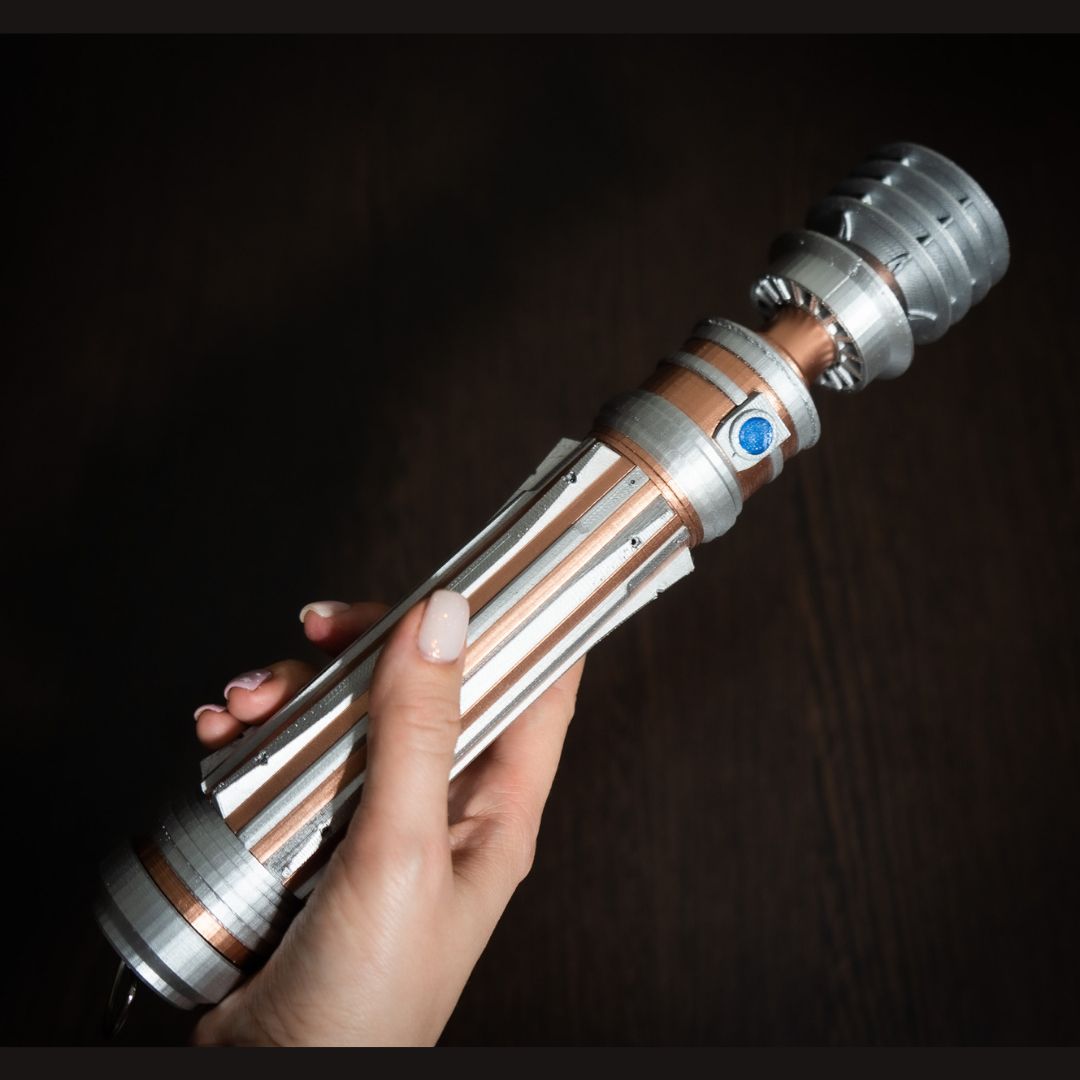 Leia Organa Lightsaber replica prop from Star Wars IX Rise of Skywalker held in hand, detailed silver and copper design for cosplay and display