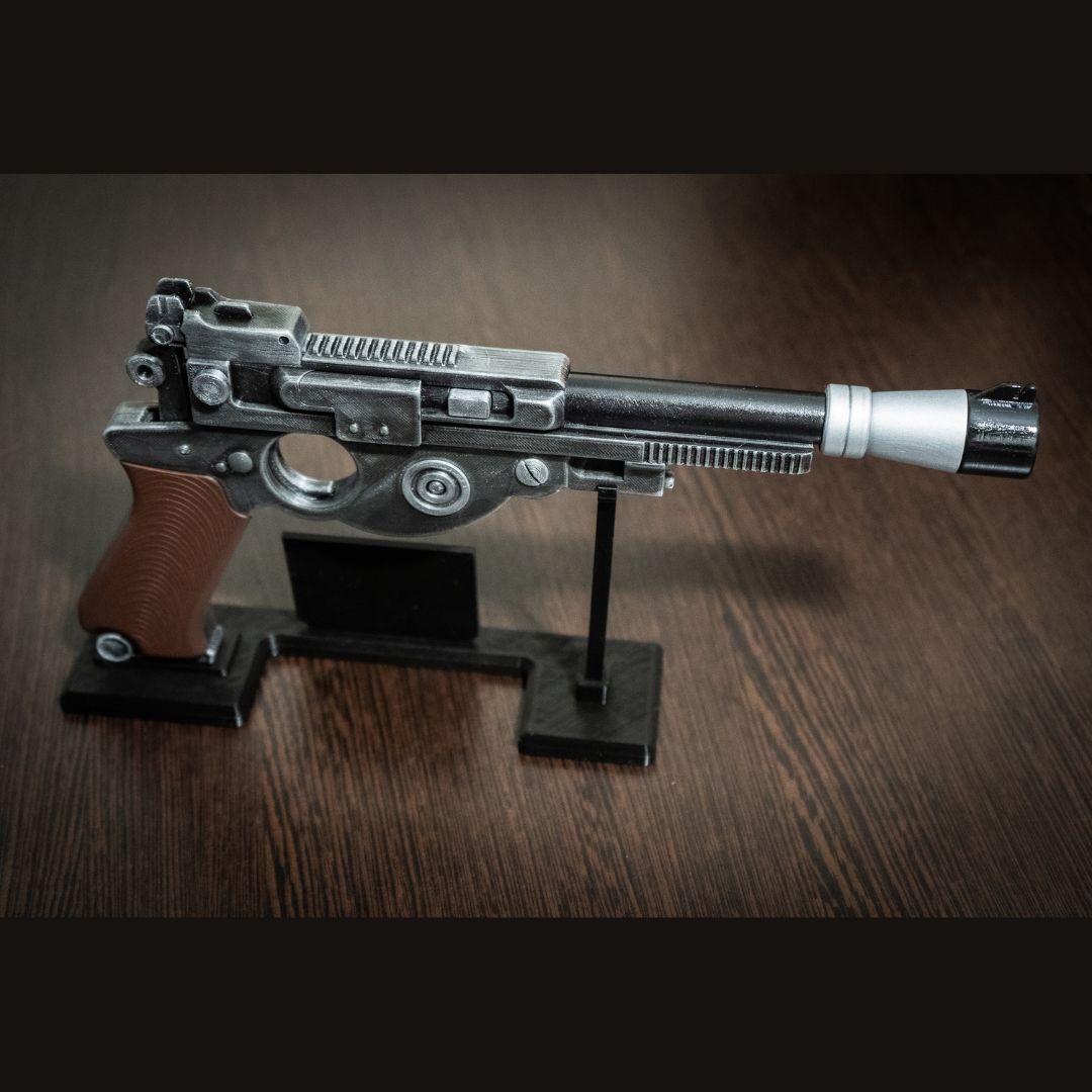 Mandalorian Blaster IB-94 Star Wars replica prop gun with display stand on wooden surface