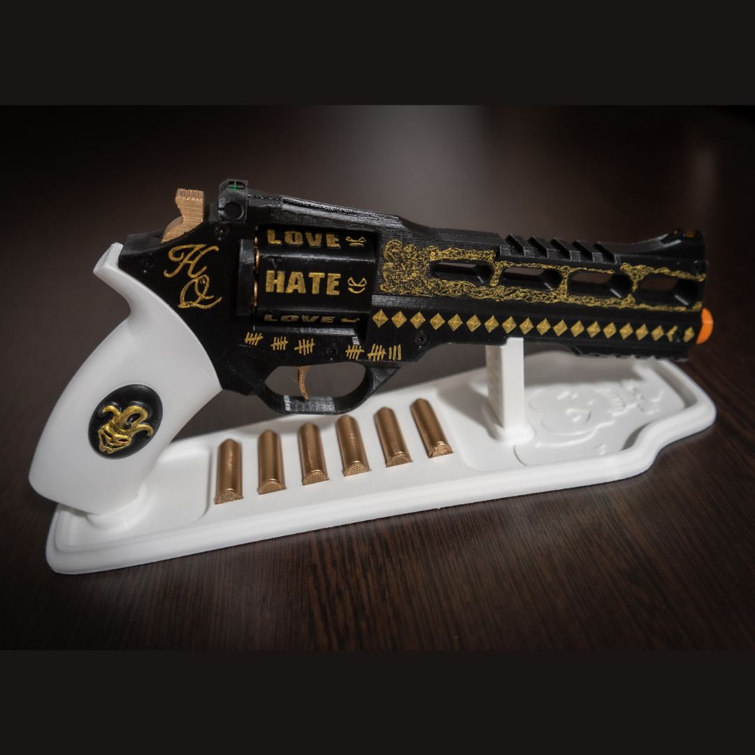 Hand-painted Harley Quinn's Revolver cosplay prop with white display stand and six bullets.