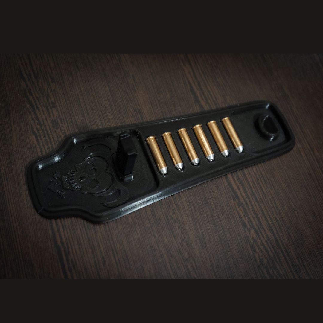 Black display stand with six gold-colored bullets for Harley Quinn's Revolver cosplay prop
