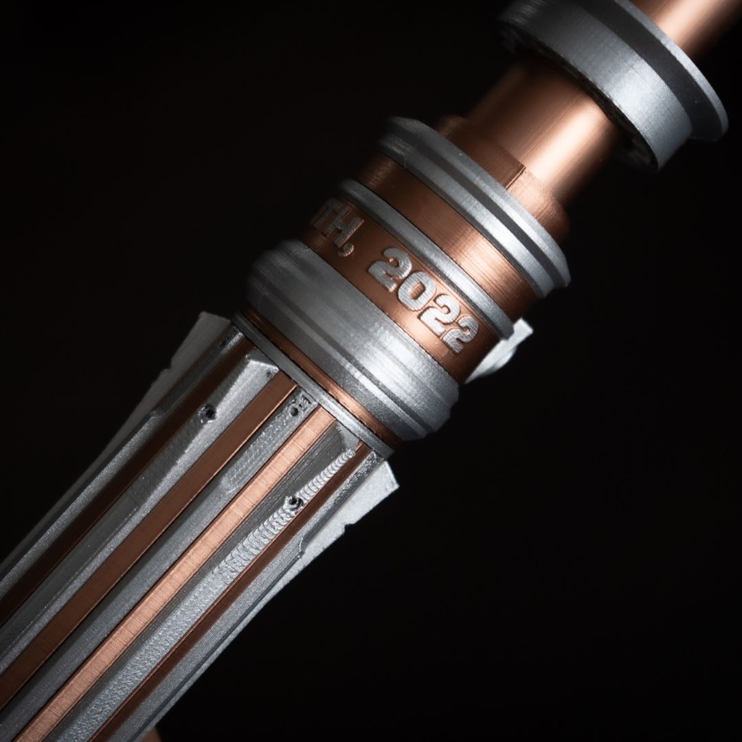 Copper and chrome Star Wars inspired bridal bouquet holder modeled after Leia's lightsaber with customizable engraved text