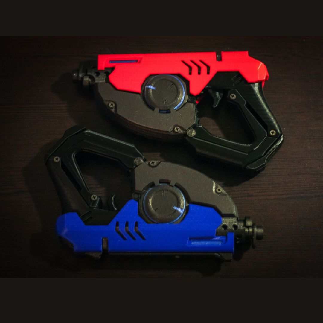 Pair of Tracer's Pulse Pistols cosplay replicas in black with red and blue accents, 3D printed gun props without LEDs.