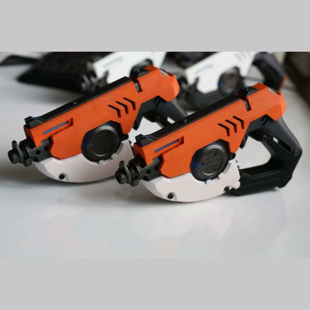 Pair of Tracer's Pulse Pistols cosplay replica guns in white and orange, 3D printed without LEDs.