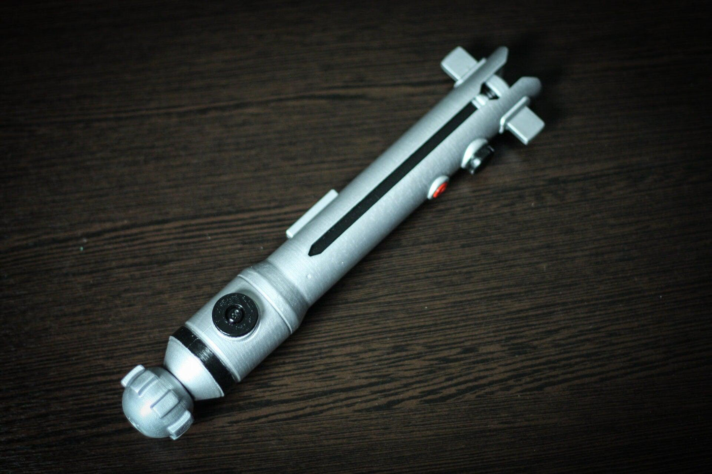 Ahsoka Tano lightsaber replica Star Wars cosplay prop in silver plastic with detailed buttons and design.
