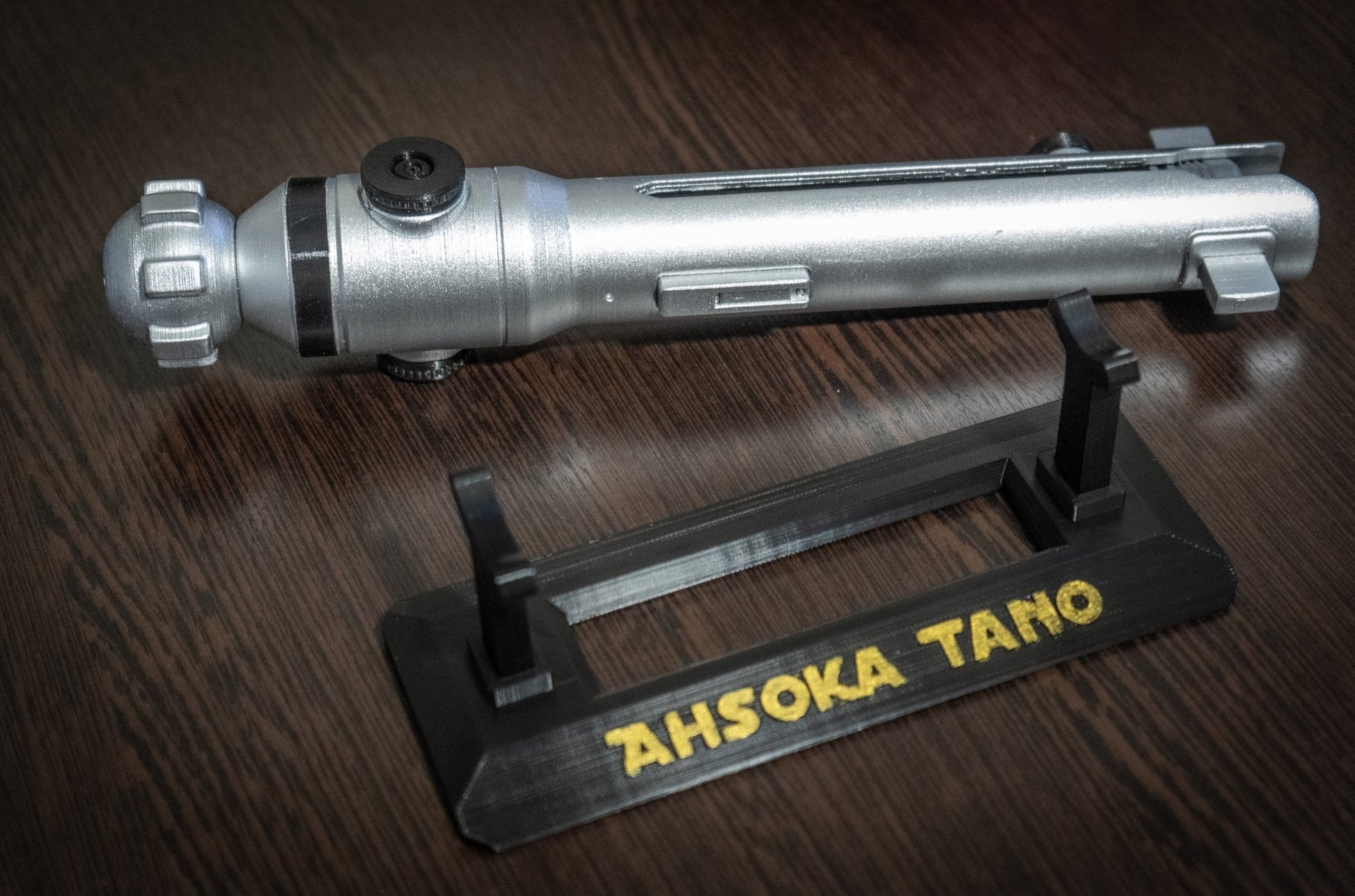 Ahsoka Tano lightsaber replica prop on stand with "Ahsoka Tano" text, star wars cosplay replica prop