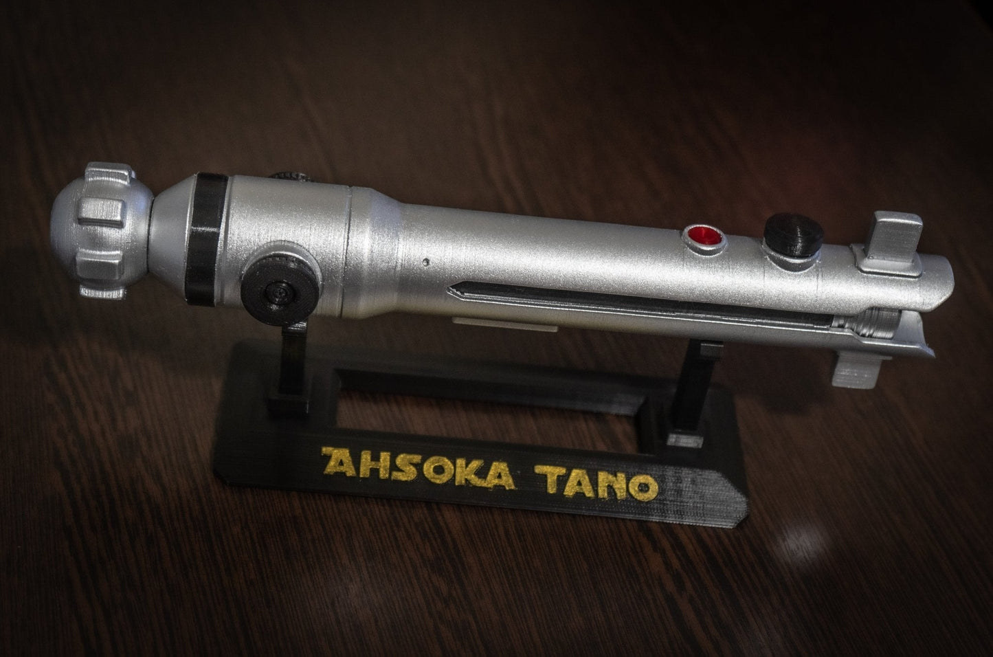 Ahsoka Tano lightsaber replica Star Wars cosplay prop on black stand with nameplate