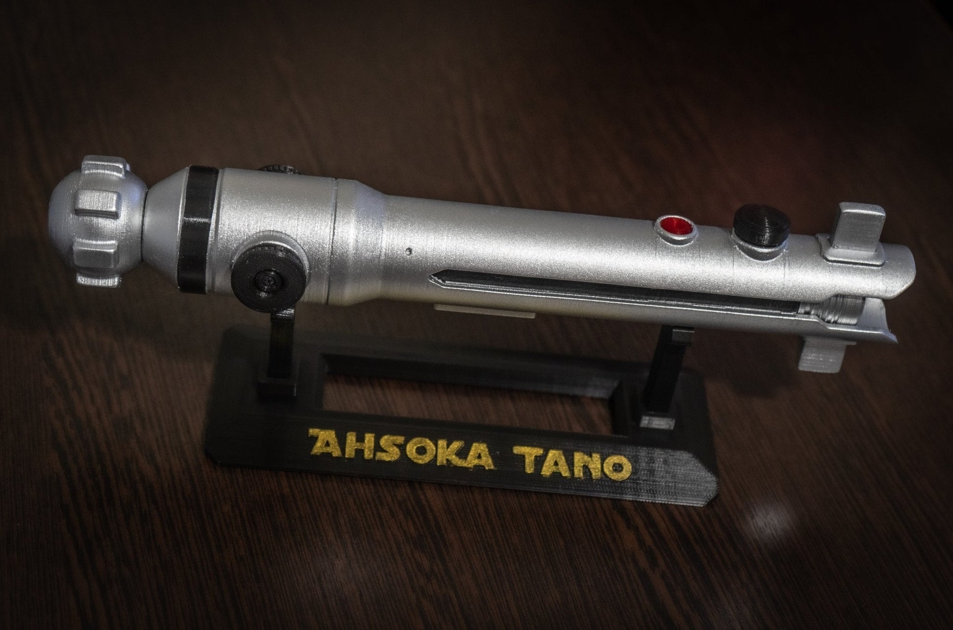 Ahsoka Tano lightsaber replica Star Wars cosplay prop on black stand with nameplate