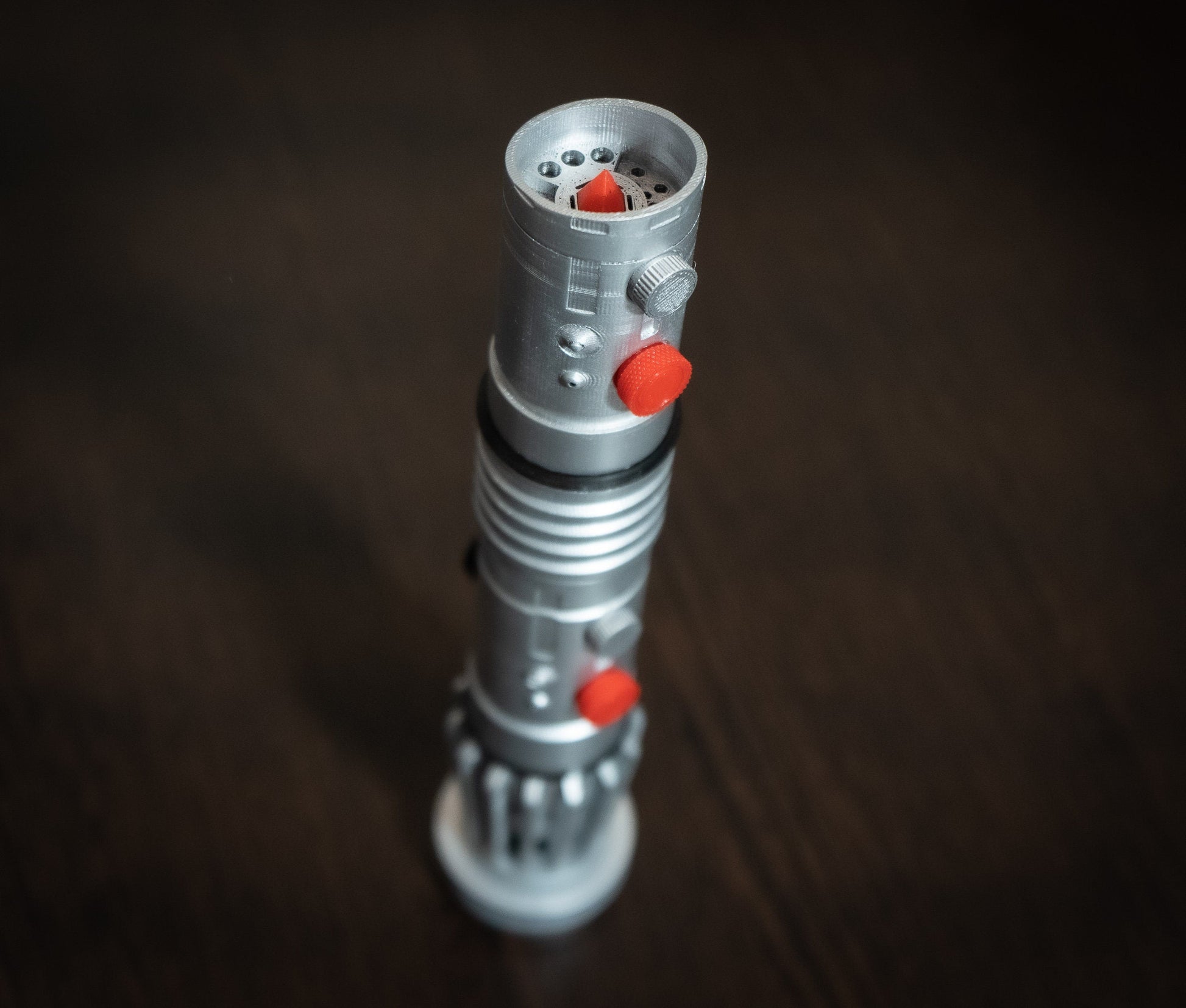 Darth Maul single-bladed lightsaber replica in silver with red buttons, 10-inch Star Wars cosplay prop made of durable plastic