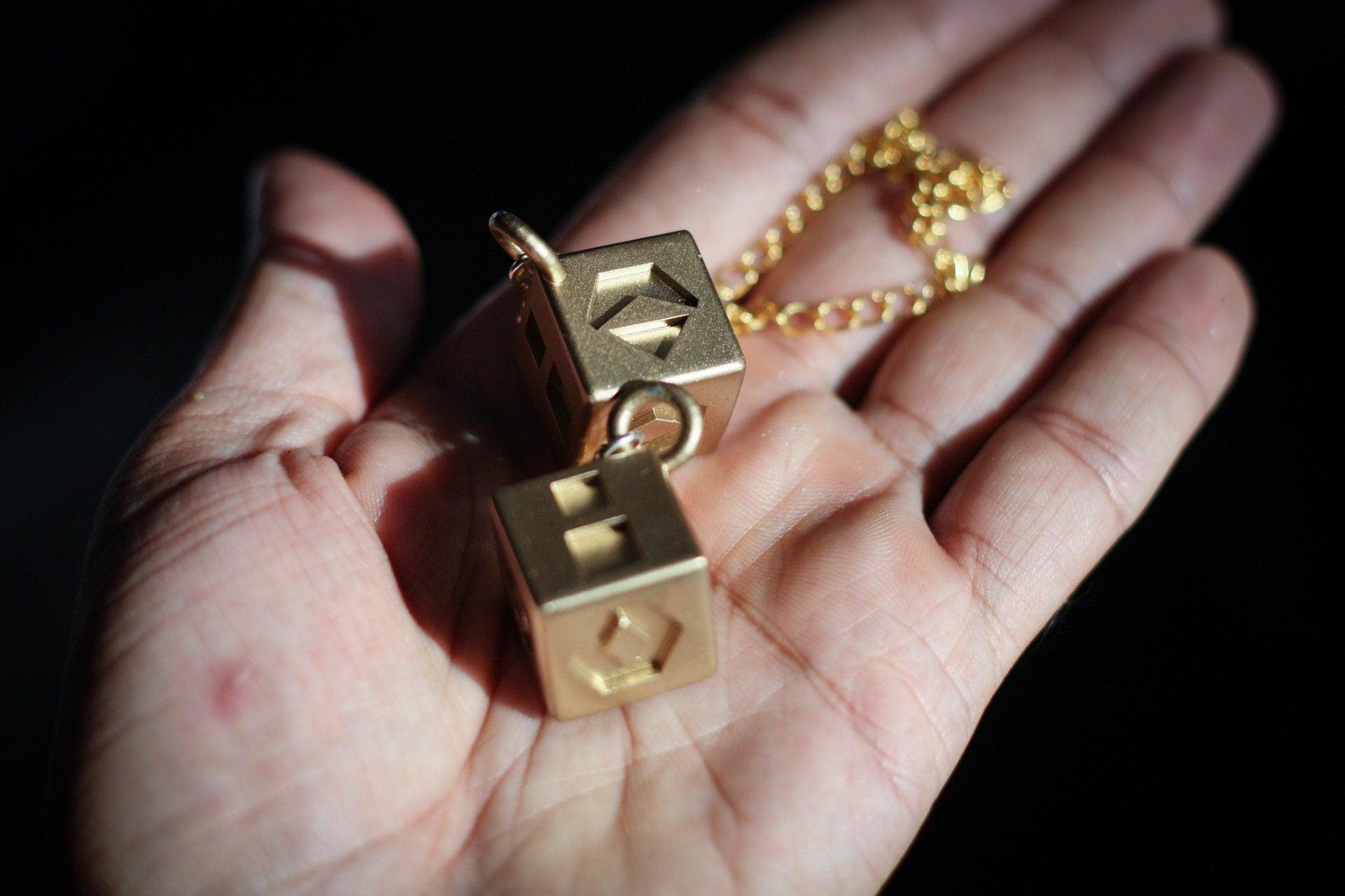 Close-up of Han Solo's golden lucky dice replica on a hand for Star Wars cosplay prop