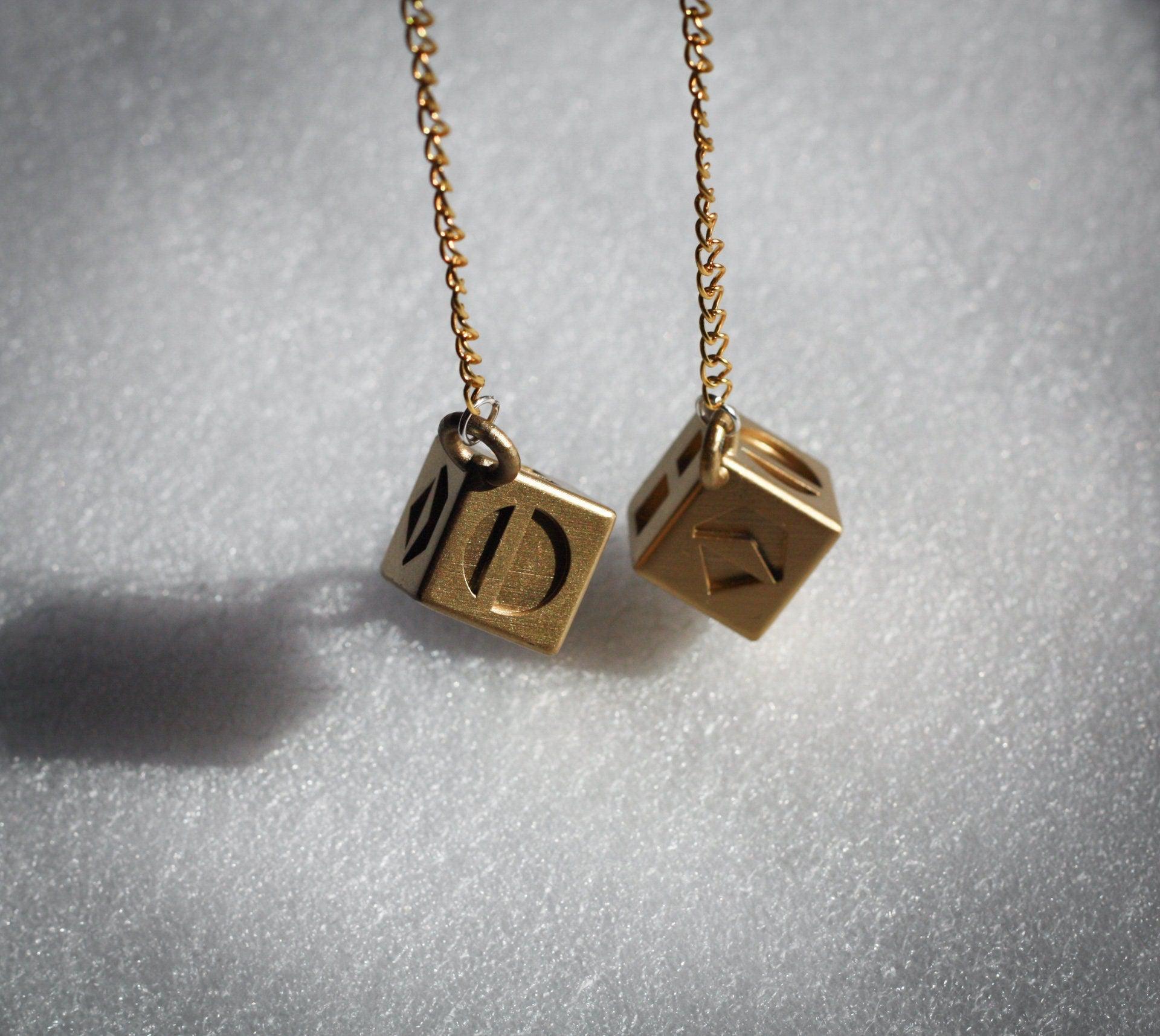 Han Solo's golden lucky dice replica on chain for Star Wars cosplay and collection
