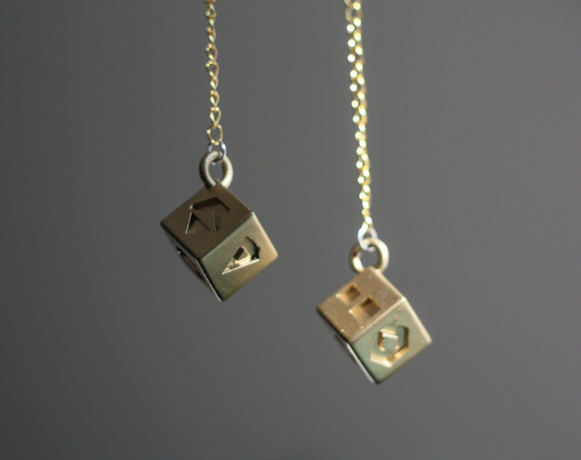 Han Solo's golden lucky dice replica on chains for Star Wars cosplay accessory