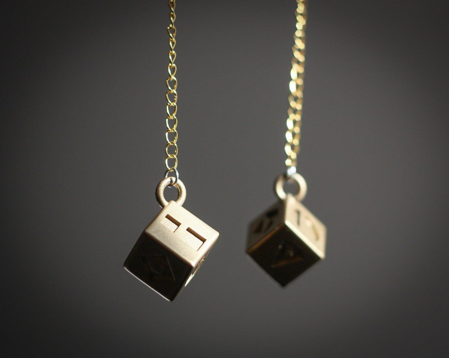 Han Solo's golden lucky dice replica on gold chains for Star Wars cosplay accessory