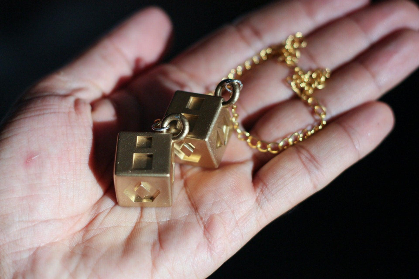 Han Solo's golden lucky dice cosplay prop on chain for Star Wars fans and collectors