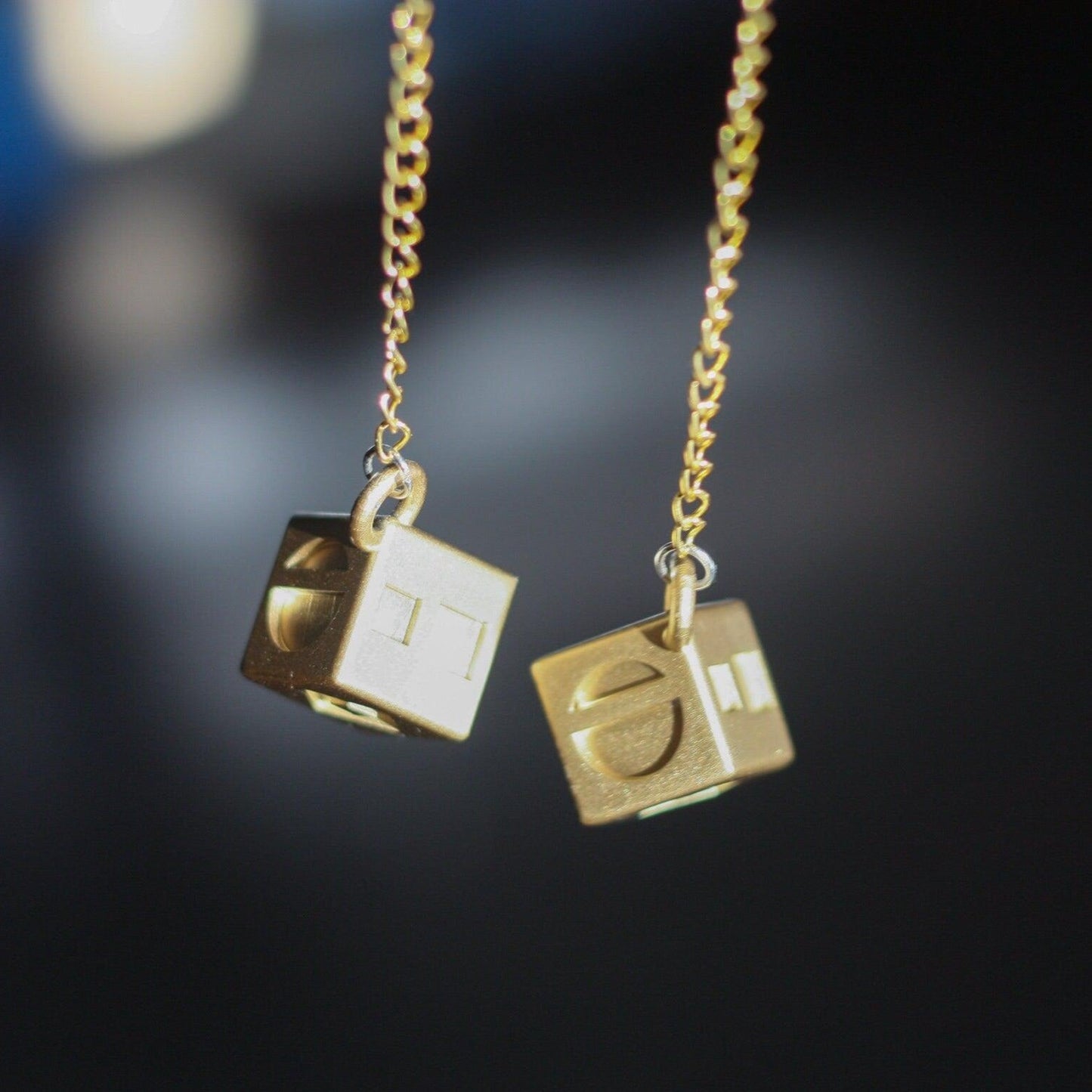 Han Solo's golden lucky dice replica on gold chains for Star Wars cosplay accessories