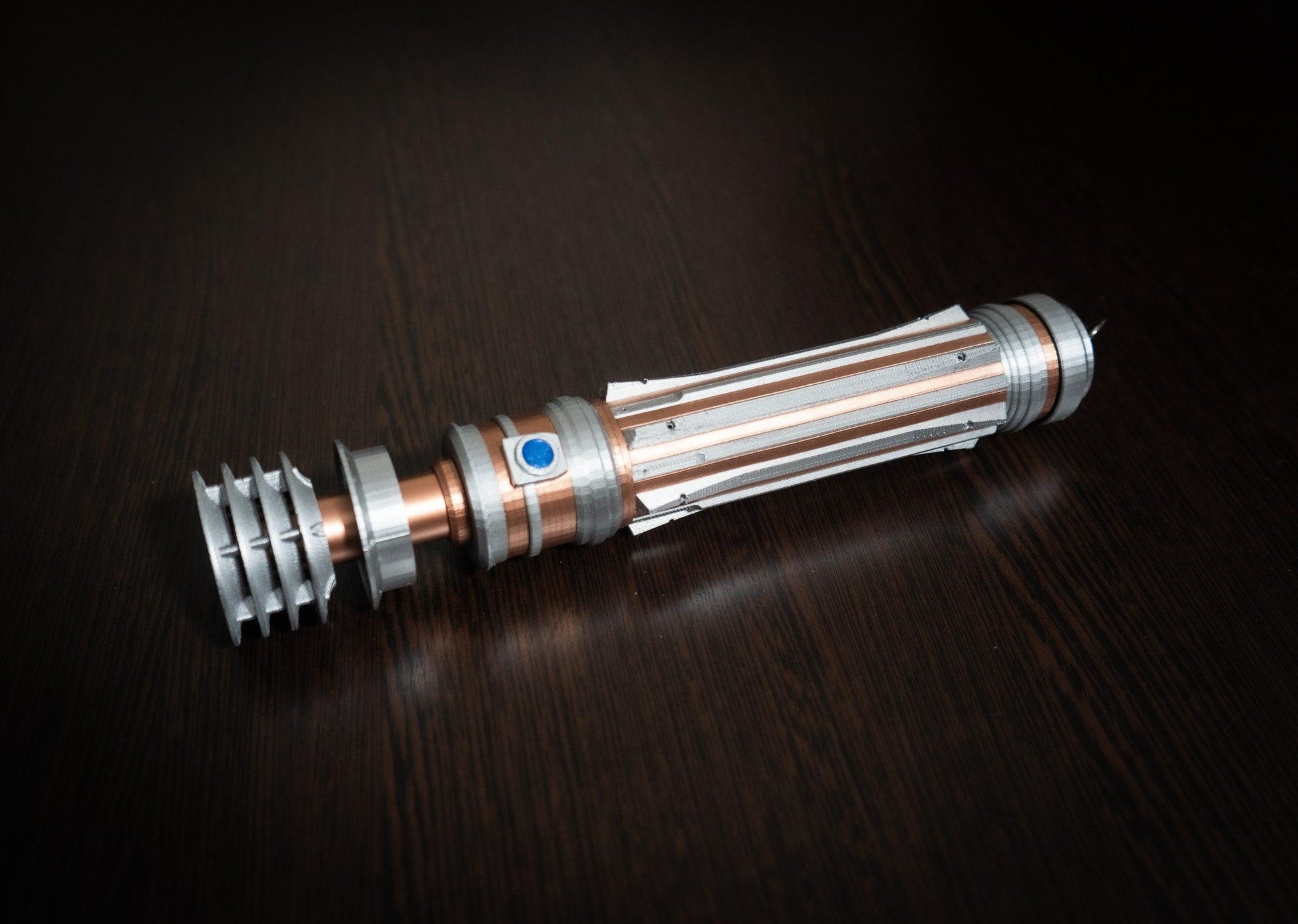 Leia Organa lightsaber replica prop from Star Wars IX displayed on dark surface