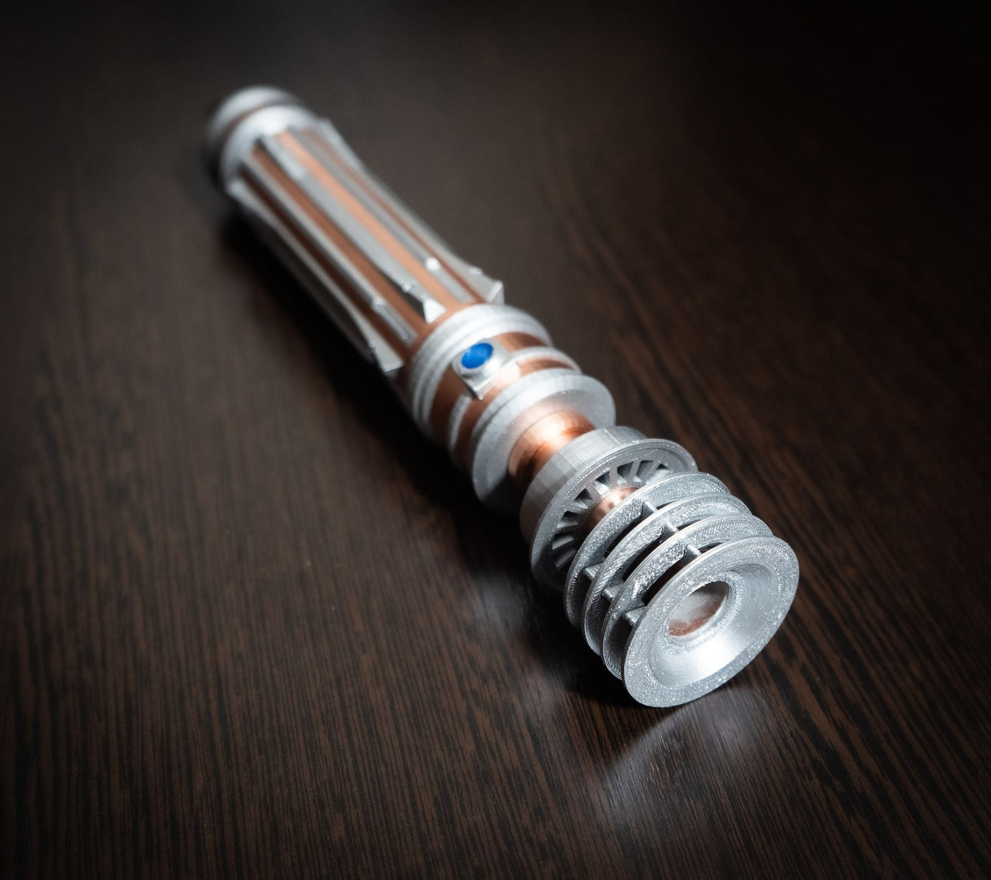 Leia Organa lightsaber replica prop from Star Wars IX Rise of Skywalker, detailed 12-inch collectible on dark wooden surface