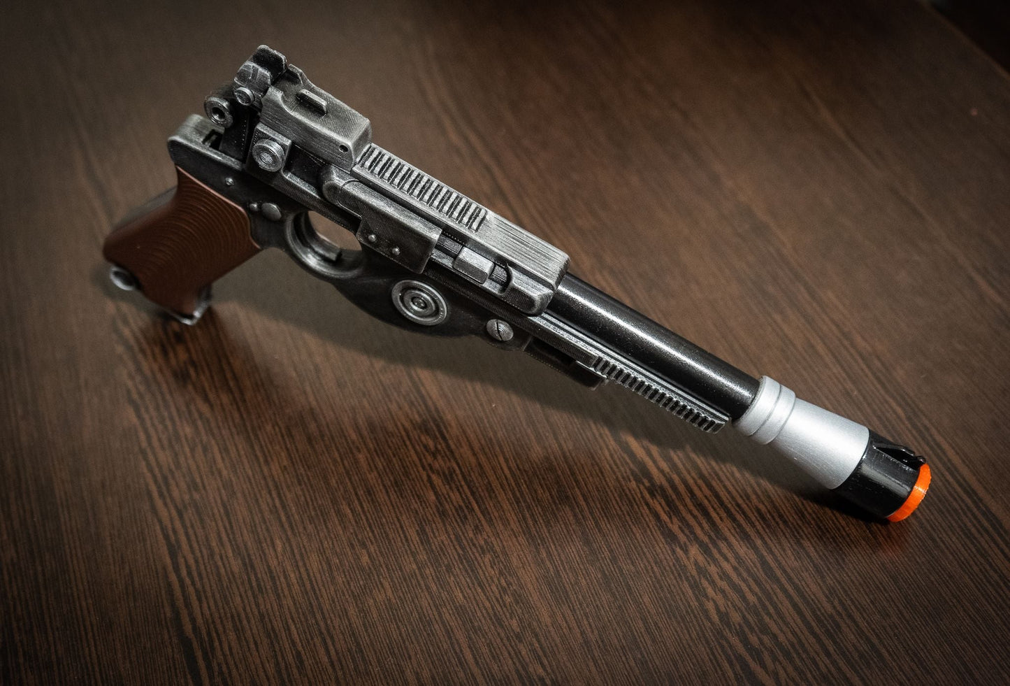 Mandalorian Blaster IB-94 Star Wars replica prop gun with detailed black and silver finish and orange safety tip for cosplay.