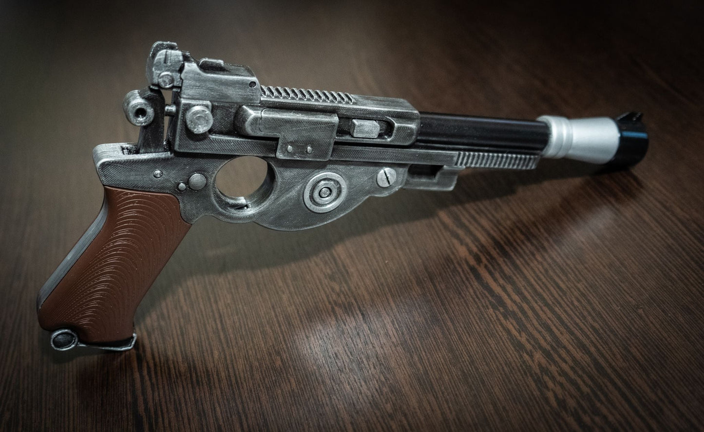 Detailed Mandalorian Blaster IB-94 Star Wars replica prop with brown grip on wooden surface for cosplay and display.