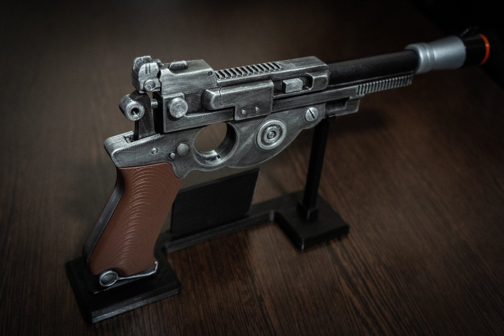 Mandalorian Blaster IB-94 Star Wars replica prop blaster with brown grip and display stand