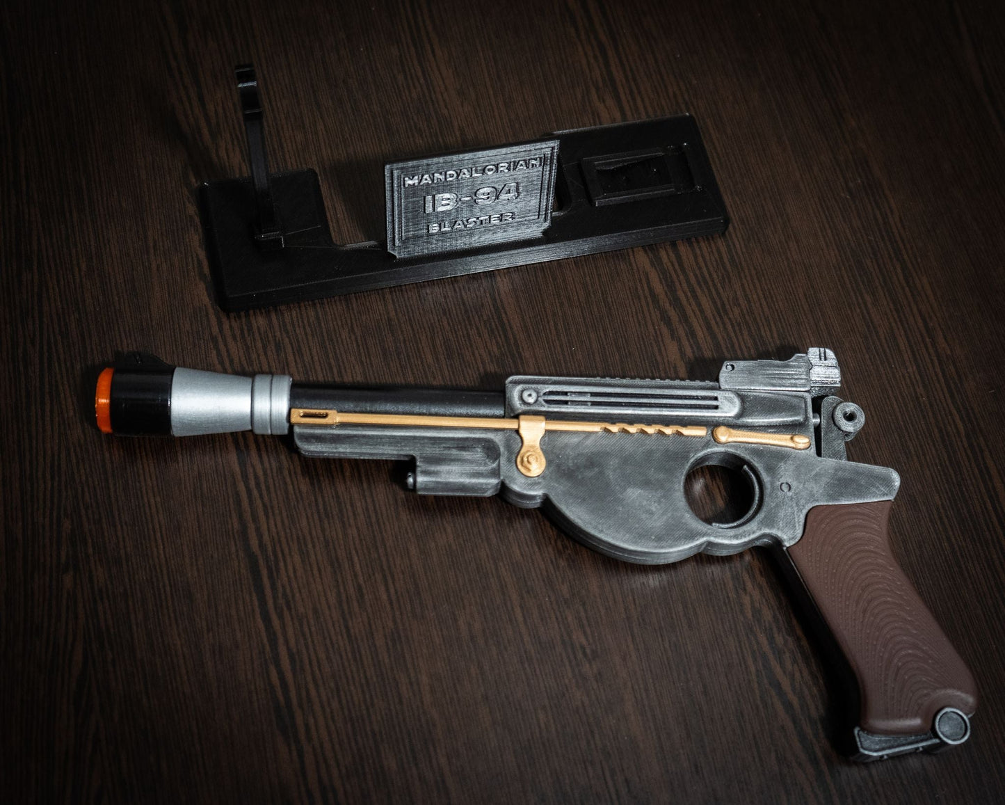 Mandalorian Blaster IB-94 Star Wars replica prop with display stand and orange safety tip for cosplay.