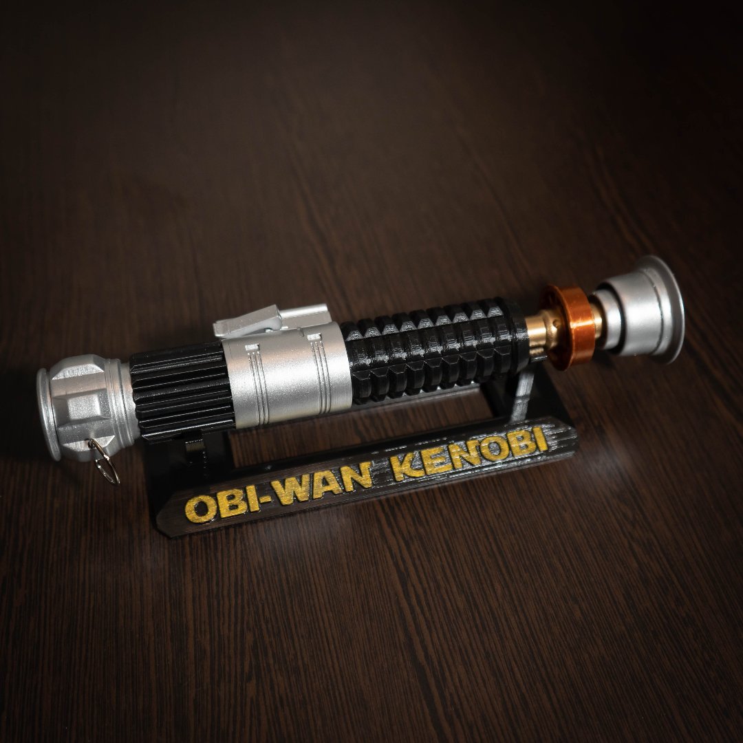 Obi-Wan Kenobi lightsaber replica on display stand with detailed black and silver design for cosplay and collectors