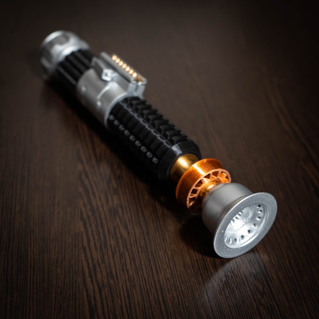 Obi-Wan Kenobi Lightsaber replica from A New Hope, detailed cosplay prop on wooden surface