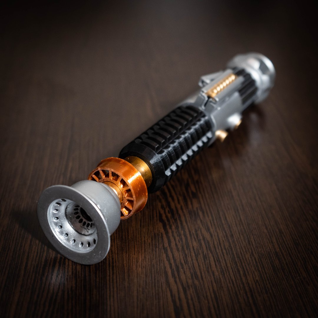 Obi-Wan Kenobi Lightsaber replica from Star Wars A New Hope, detailed cosplay prop with black, silver, and copper finish on wooden surface