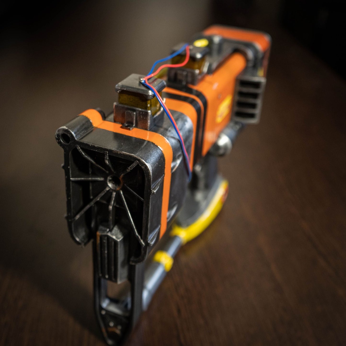 3D printed Fallout New Vegas AEP7 laser pistol cosplay prop with orange and black weathered detailing