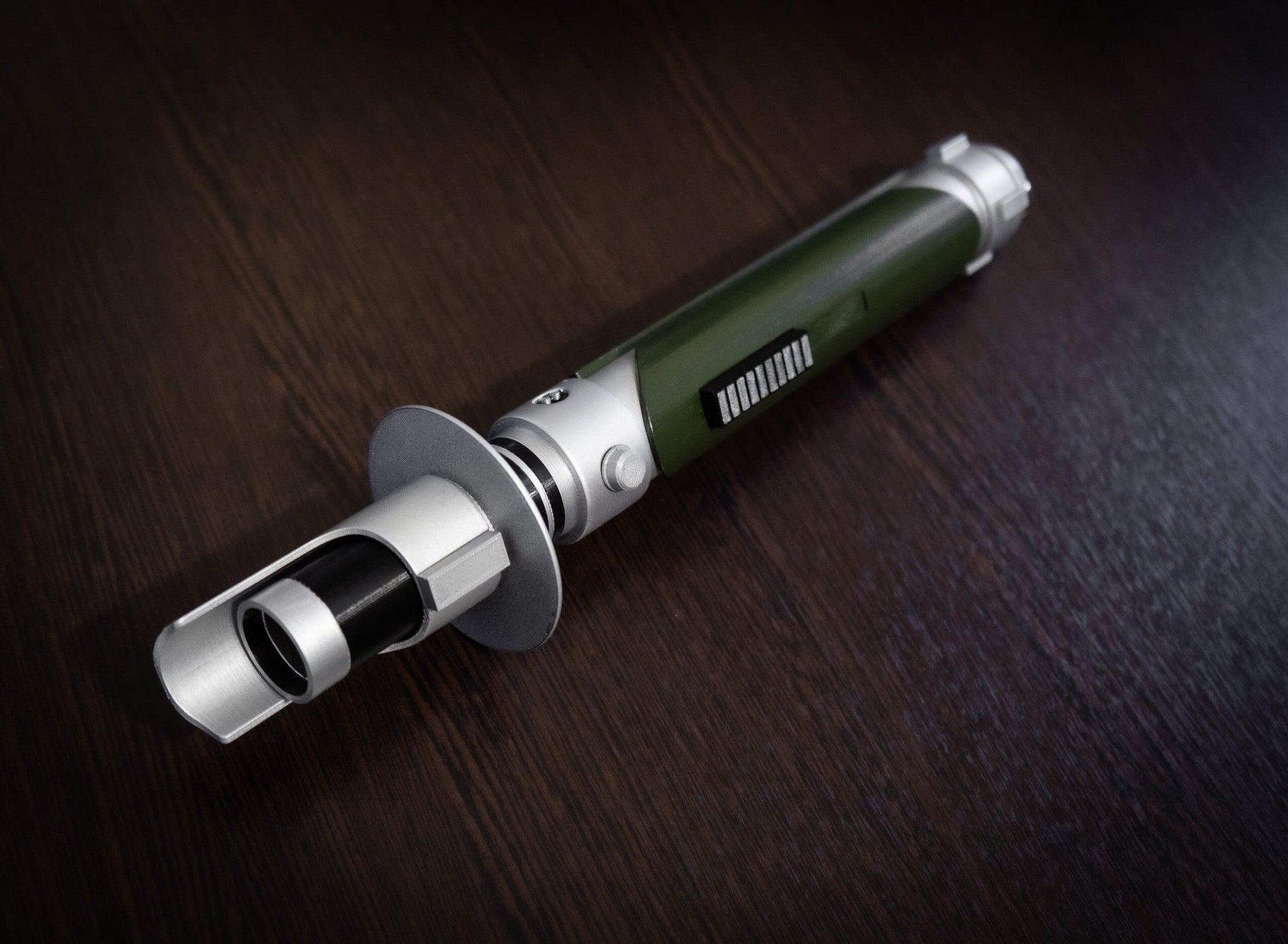 Star Wars inspired bridal bouquet holder shaped like Kanan Jarrus lightsaber on wooden surface