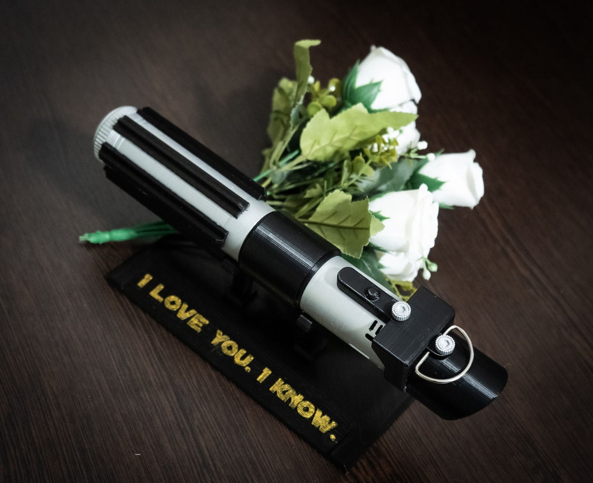 Star Wars inspired Darth Vader lightsaber bridal bouquet holder with white roses and personalized embroidered base reading "I love you, I know."