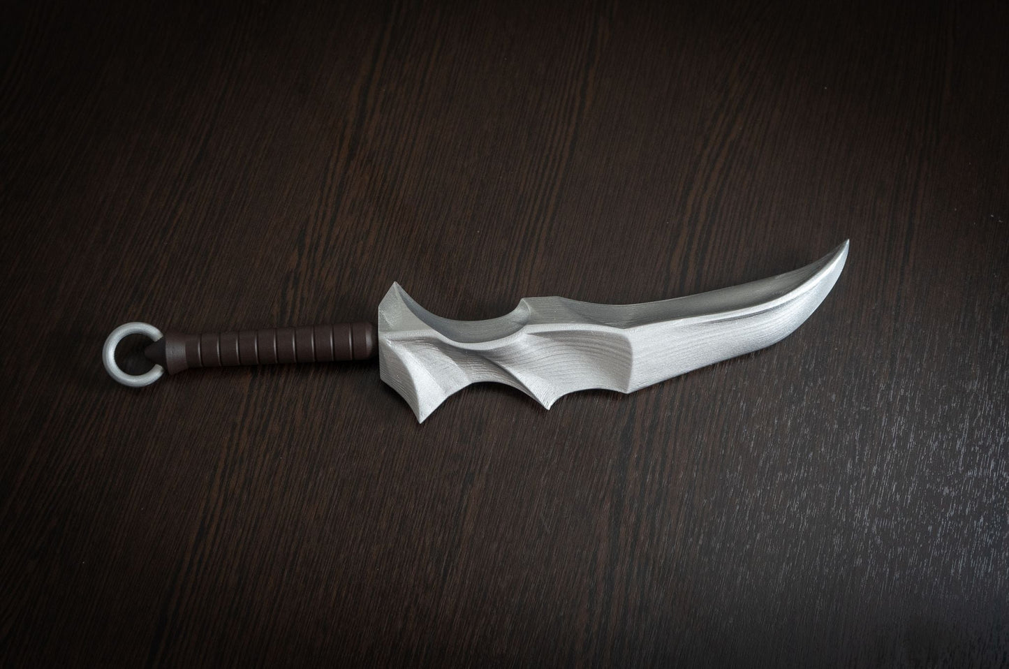 Vampire Blade cosplay prop replica inspired by Overlord, 14.8-inch hand-painted plastic dagger with brown handle on dark wood surface.