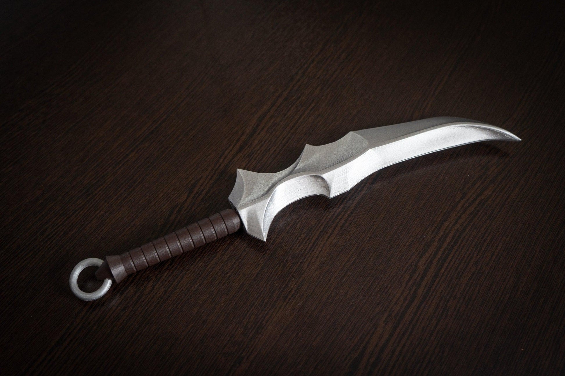 Vampire Blade cosplay prop replica with silver blade and brown handle on dark wood background