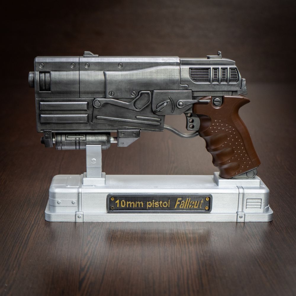 Metallic 10mm pistol model from Fallout on a wooden surface