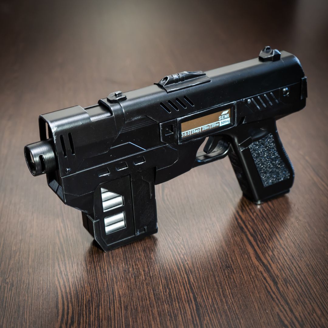 Black futuristic gun on a wooden surface