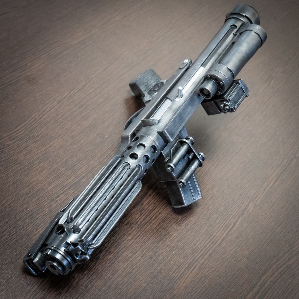 Metallic futuristic weapon on a wooden surface