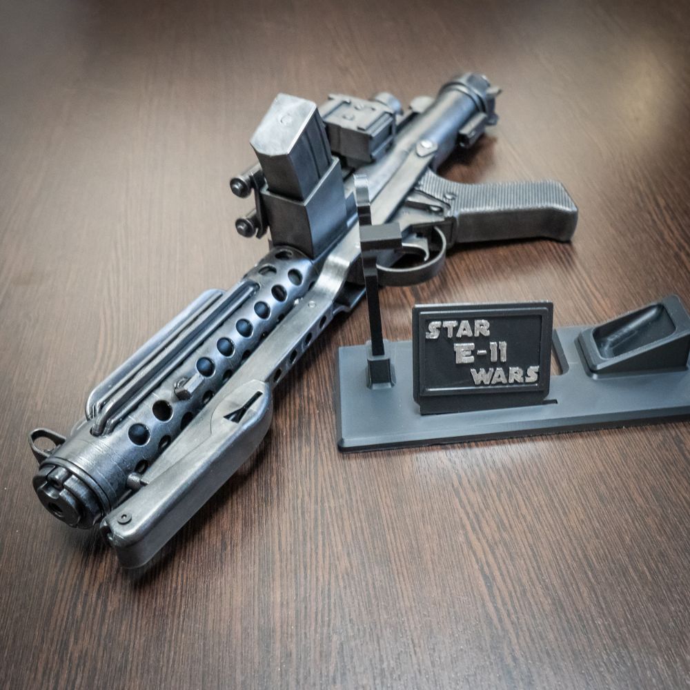 Model of a Star Wars E-11 weapon on a wooden surface