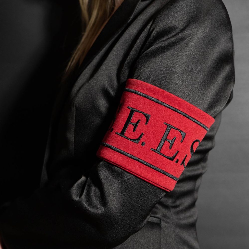 Black robe with red and black 'E.E.' emblem on a dark background