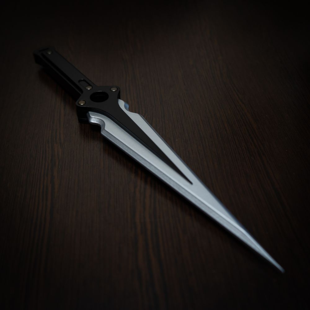 Futuristic knife with a metallic blade on a dark wooden surface